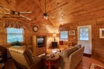 Living room features free standing gas fireplace and flat screen tv